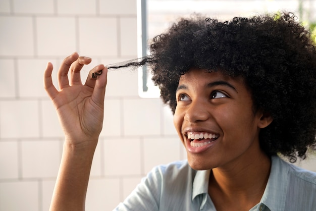 Young black person taking care of afro hair