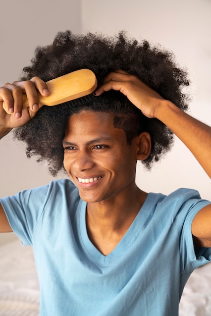 Young black person taking care of afro hair