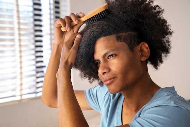 Young black person taking care of afro hair