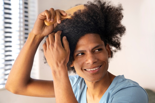 Young black person taking care of afro hair
