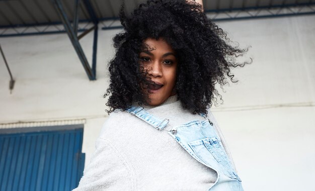 young black woman with afro hair laughing and enjoying