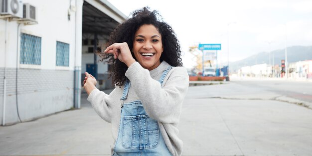 young black woman with afro hair laughing and enjoying