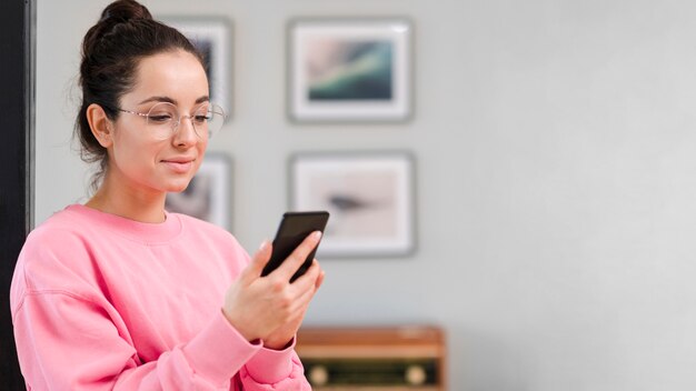 Young blogger checking her smartphone