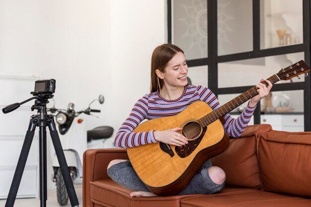 Young blogger playing the guitar