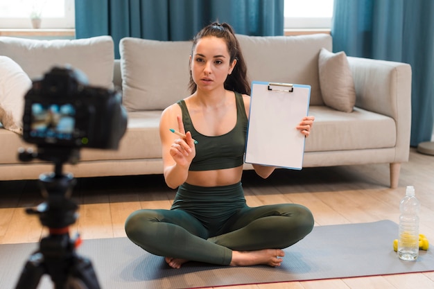 Young blogger presenting training plan on camera