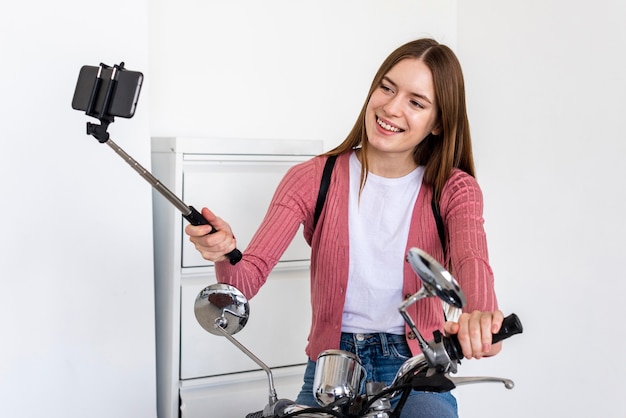 Young blogger recording herself sitting on her motorbike