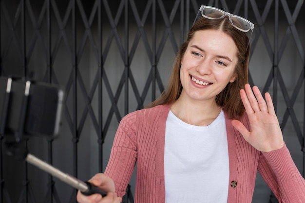 Young blogger recording herself and waiving