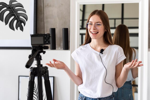 Young blogger recording with professional camera and mic