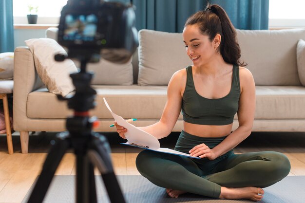 Young blogger in sportswear recording herself