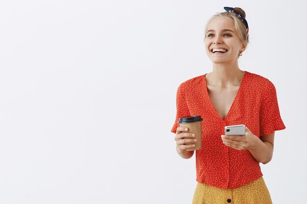 young blond girl posing against the white wall