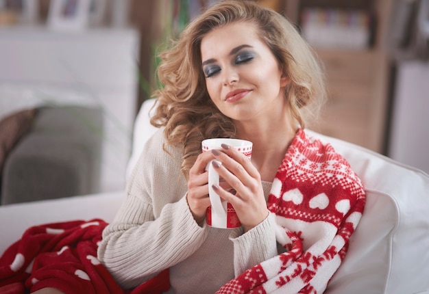 Young blond woman drinking hot chocolate