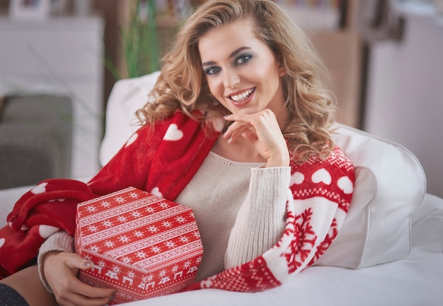 Young blond woman holding Christmas present