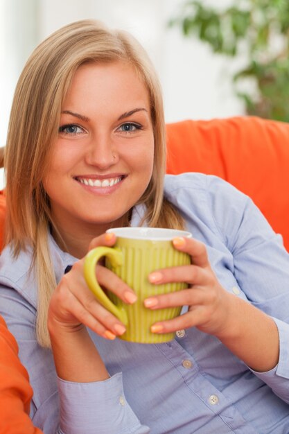 Young blond woman with mug