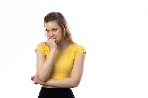 Young blond woman with yellow t-shirt thinking