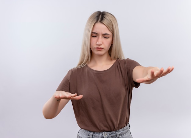 Young blonde girl walking with closed eyes on isolated white wall