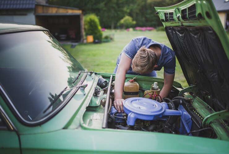 Free Photo young blonde male tired and disappointed trying to fix an old car