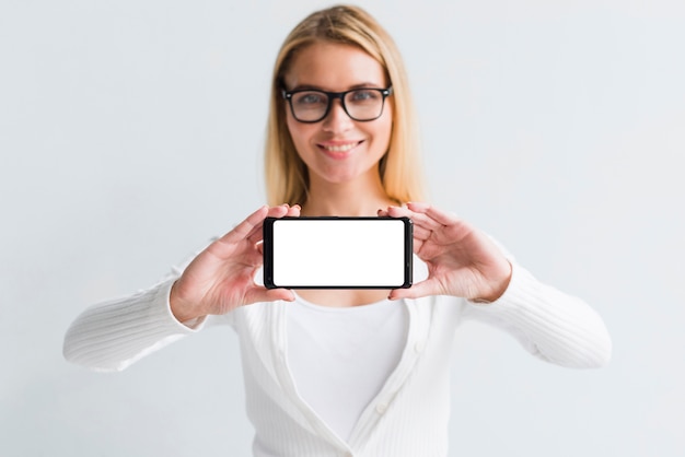 Young blonde showing smartphone screen