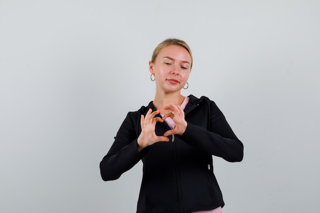 Free photo young blonde woman in a black jacket