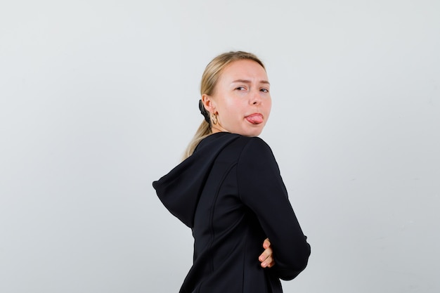 Young blonde woman in a black jacket