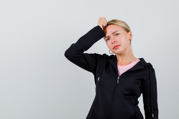 Young blonde woman in a black jacket