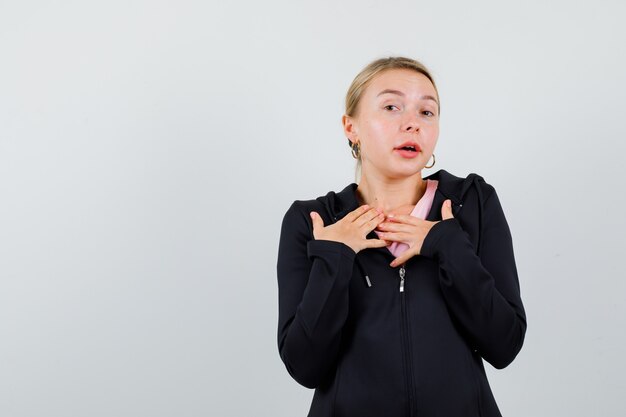 Young blonde woman in a black jacket