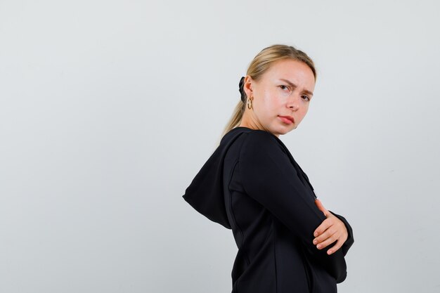 Young blonde woman in a black jacket