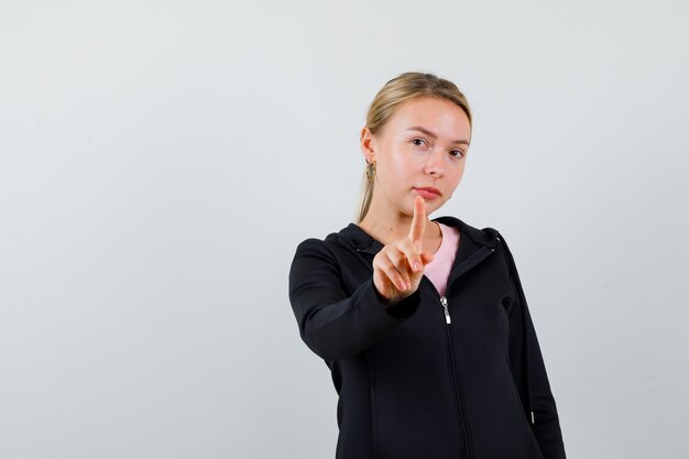 Young blonde woman in a black jacket