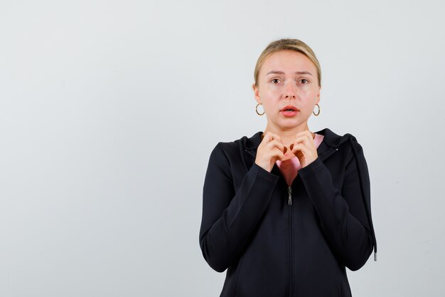 Young blonde woman in a black jacket