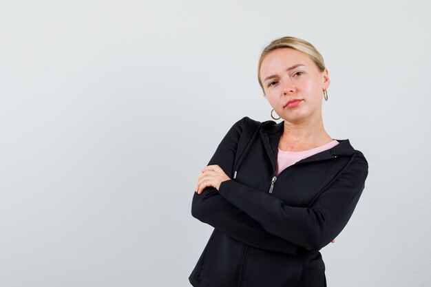 Young blonde woman in a black jacket