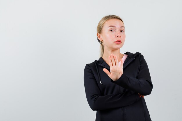 Young blonde woman in a black jacket