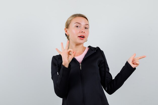 Young blonde woman in a black jacket