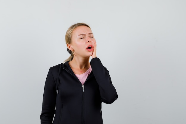 Young blonde woman in a black jacket