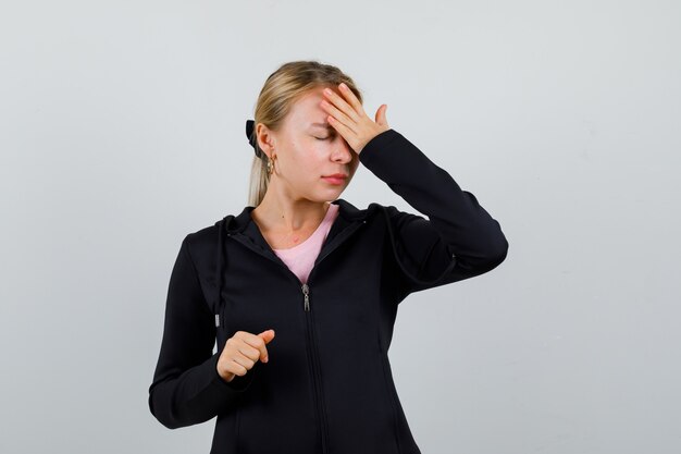 Young blonde woman in a black jacket