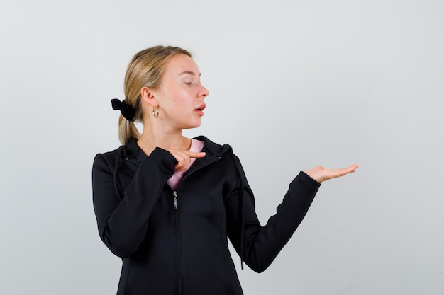 Young blonde woman in a black jacket