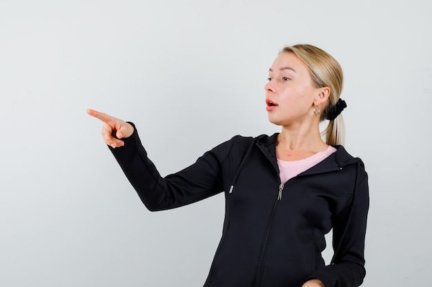 Free photo young blonde woman in a black jacket