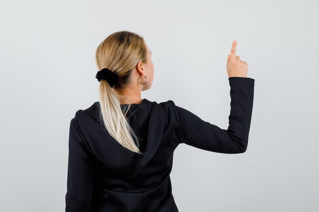 Young blonde woman in a black jacket