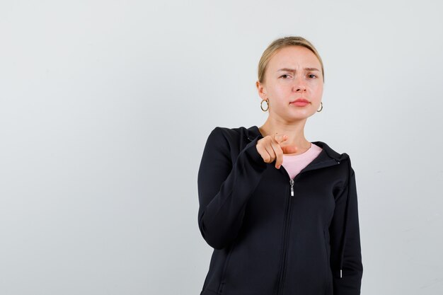 Young blonde woman in a black jacket