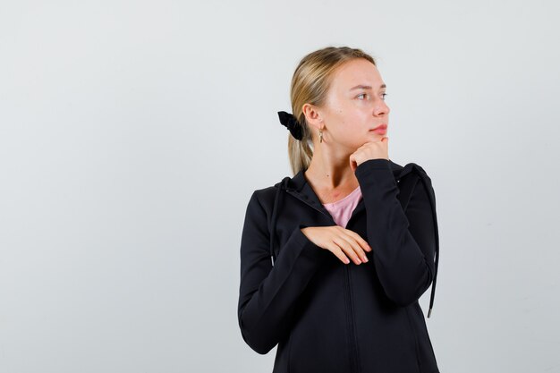 Young blonde woman in a black jacket