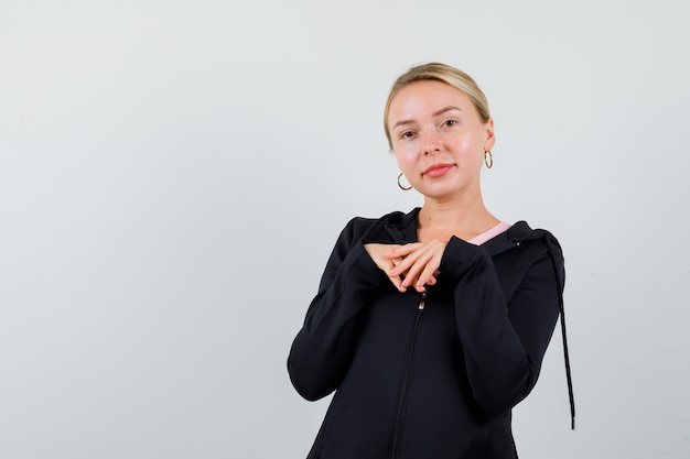 Young blonde woman in a black jacket