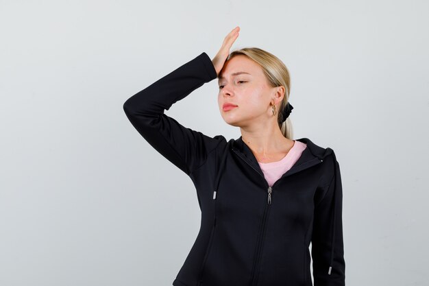 Young blonde woman in a black jacket