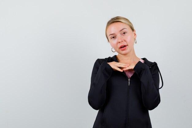 Young blonde woman in a black jacket