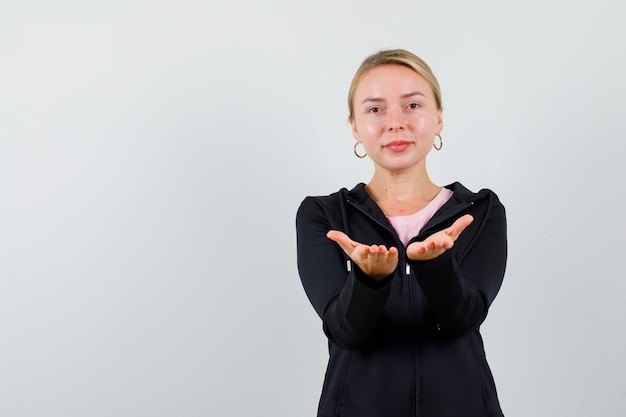 Free photo young blonde woman in a black jacket