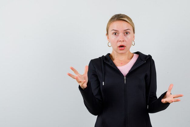 Young blonde woman in a black jacket