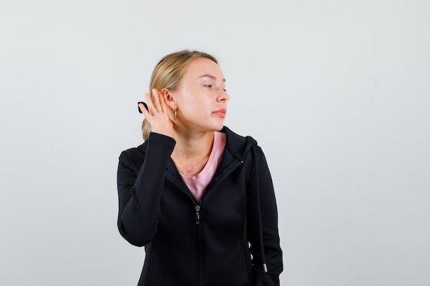 Young blonde woman in a black jacket