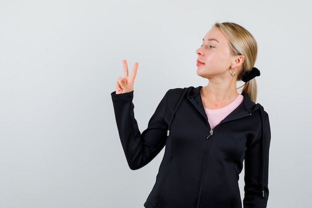 Young blonde woman in a black jacket