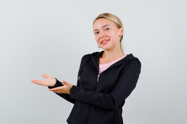 Young blonde woman in a black jacket