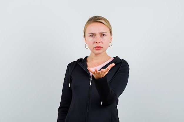 Young blonde woman in a black jacket