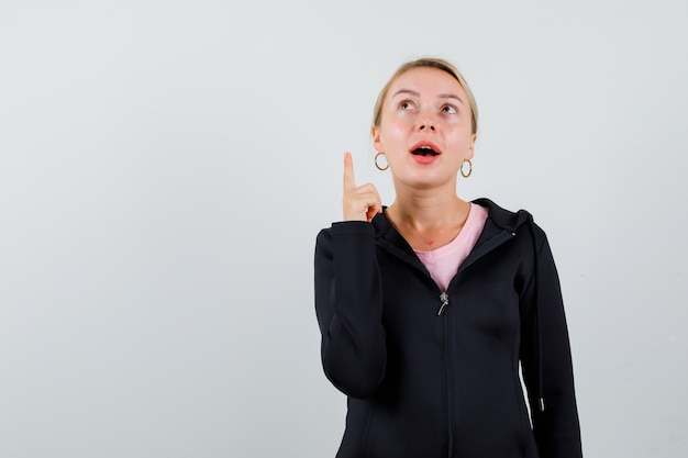 Young blonde woman in a black jacket