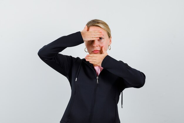 Young blonde woman in a black jacket