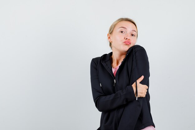 Young blonde woman in a black jacket